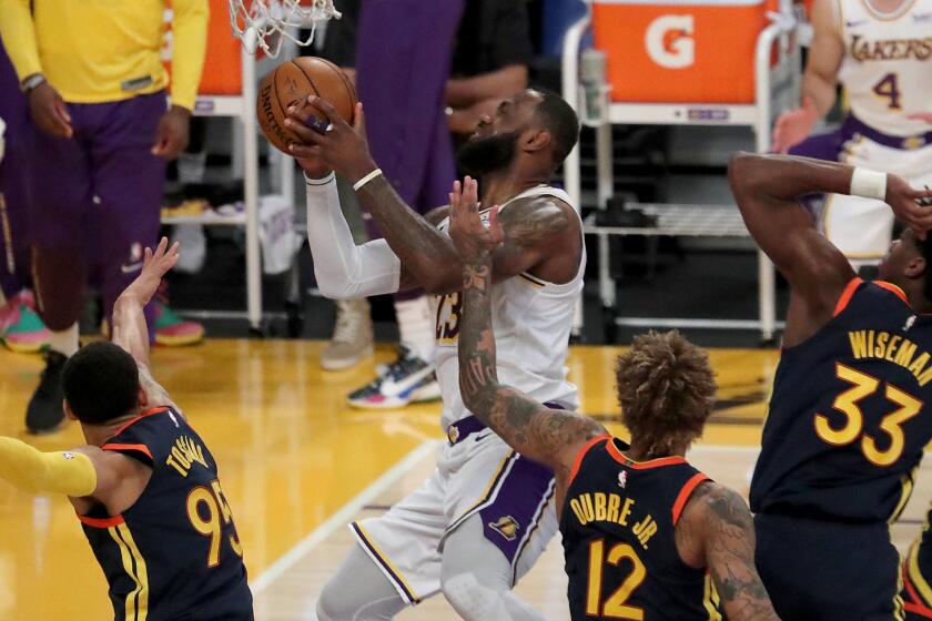 LOS ANGELES, CALIF. - FEB. 28, 2021. Lakers forward LeBron James draws four Warriors defenders.