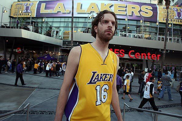 Pau Gasol look-alike Michael Fanter of Lancaster walks outside Staples Center before the start of the Lakers opening game of the 2010-11 season.