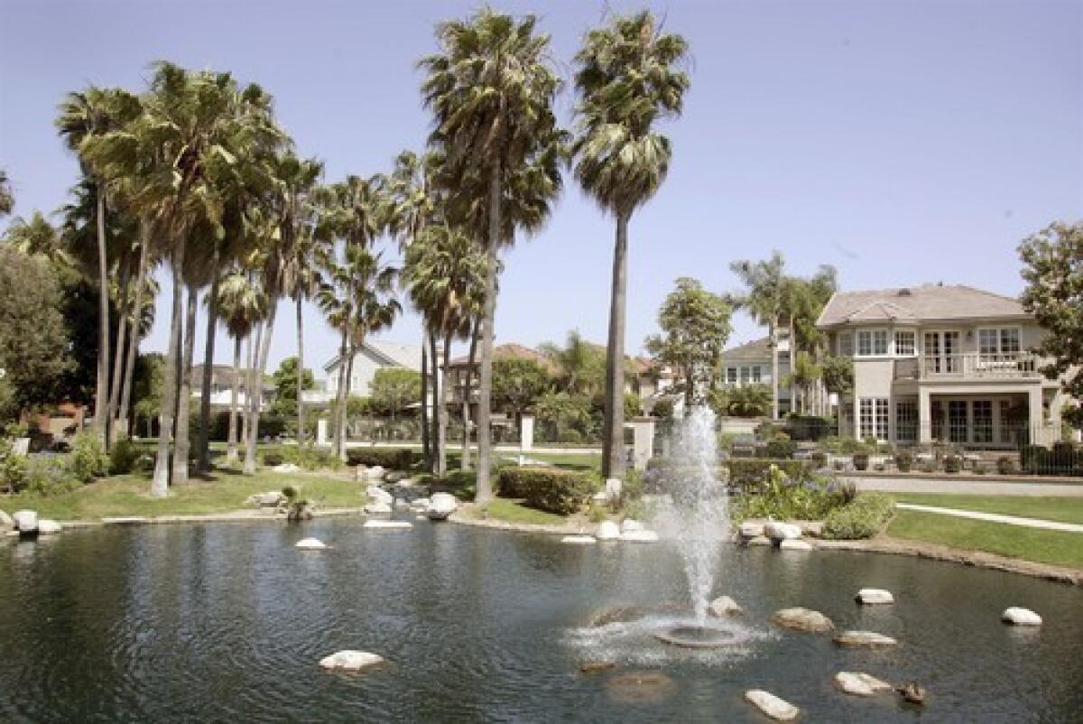 Elegant homes surround a small lake in the SeaCliff on the Greens development in Huntington Beach.
