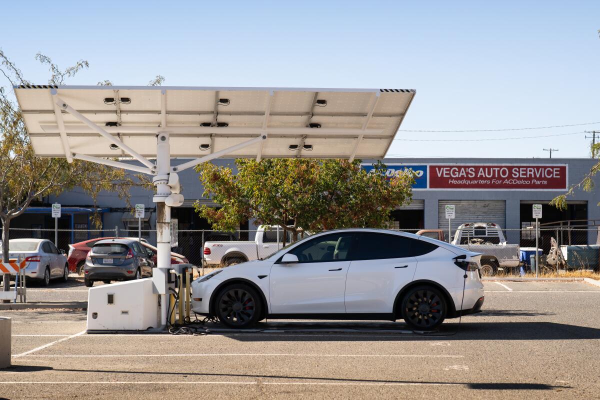 An automobile charges at a lone charging station in downtown Coalinga. 
