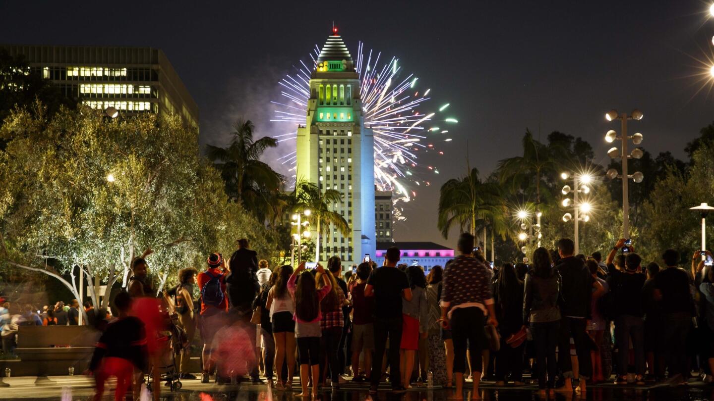 Fireworks can be seen behind City Hall at the 4th annual Grand Park + Music Center's Fourth of July Block Party.