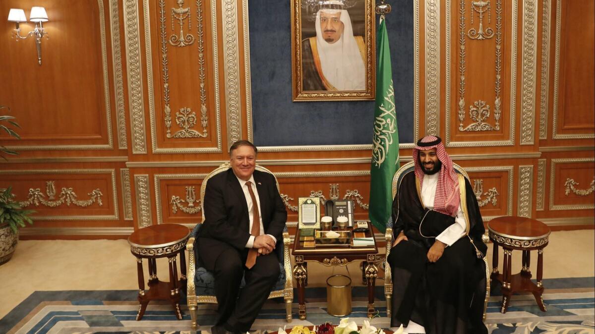 Secretary of State Mike Pompeo meets with the Saudi Crown Prince Mohammed bin Salman under a portrait of Saudi King Salman in Riyadh, Saudi Arabia on Oct. 16.