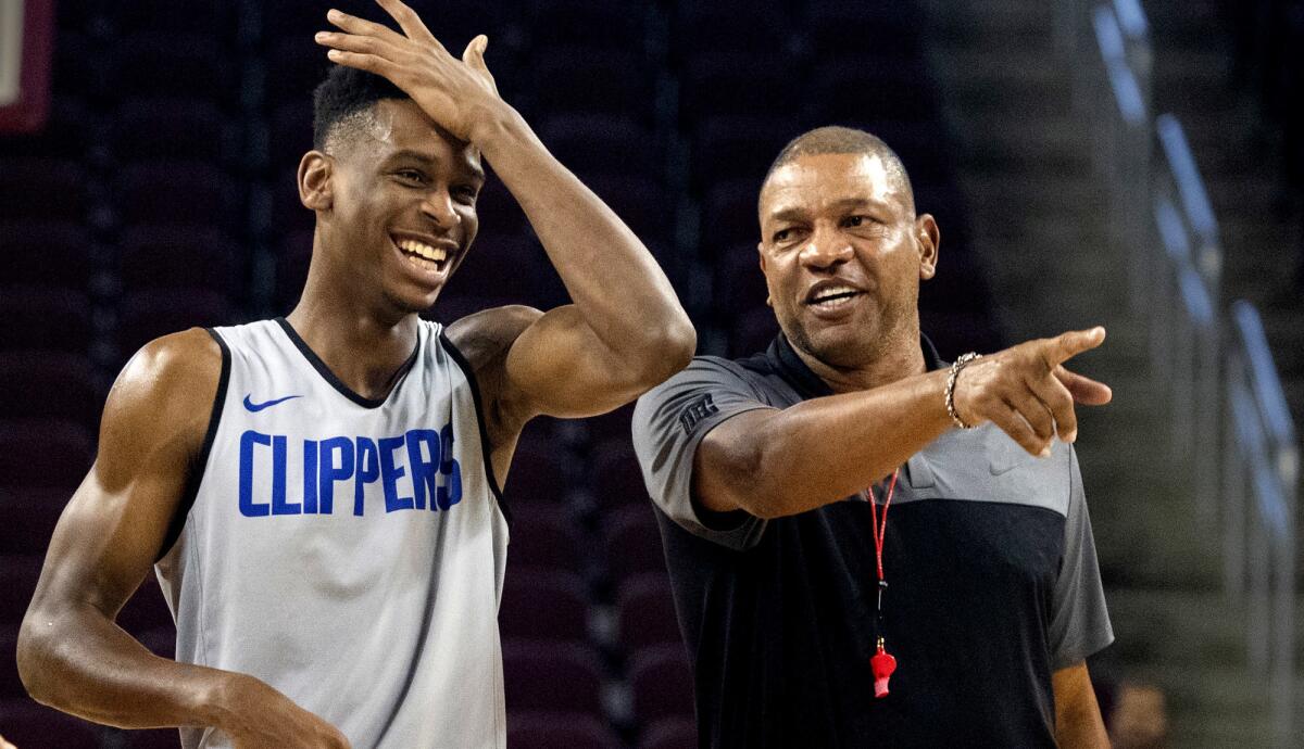 Clippers coach Doc Rivers helps point guard Shai Gilgeous-Alexander introduce teammates during a practice open to the public at the Galen Center on Oct. 8.