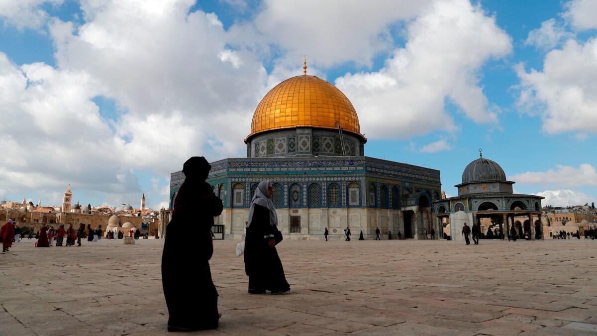 Palestinian Muslim worshipers walk past the Dome of the Rock mosque at Al Aqsa compound in Jerusalem's Old City on Dec. 15, 2017.