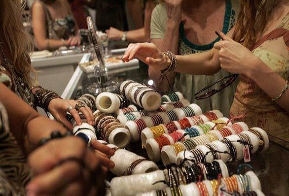 Shoppers try on accessories at the Fred Segal on Melrose Avenue during L.A.'s Fashion's Night Out festivities.