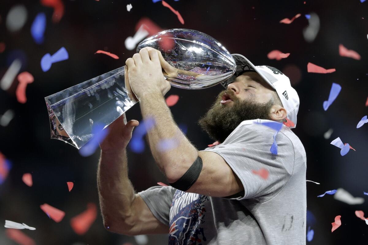 New England Patriots' Julian Edelman holds the trophy after the NFL Super Bowl 53 football game against the Los Angeles Rams, Sunday, Feb. 3, 2019, in Atlanta. The Patriots won 13-3. Edelman was named the Most Valuable Player.
