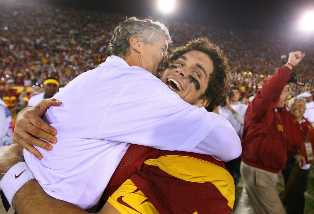 Pete Carroll, left, and Matt Leinert celebrate USC's win over UCLA in 2005.