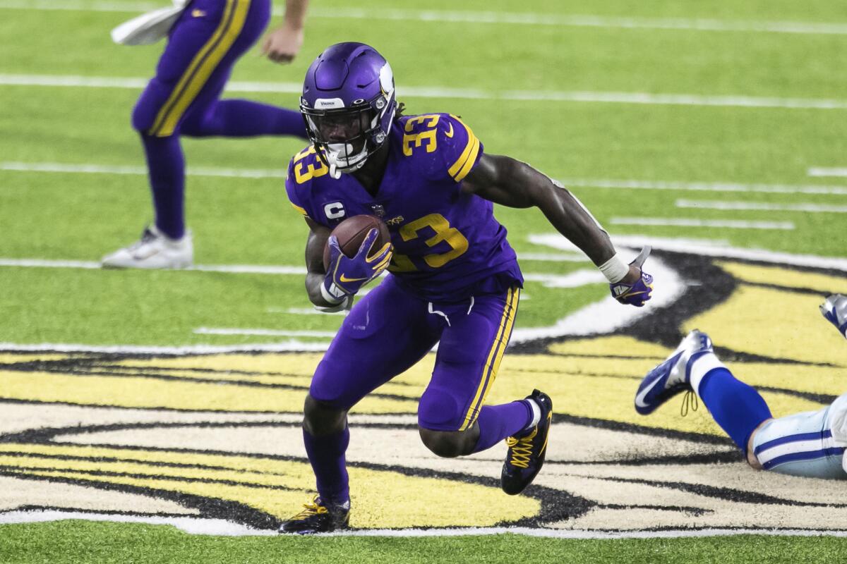 Minnesota Vikings running back Dalvin Cook runs with the ball against the Dallas Cowboys on Sunday.