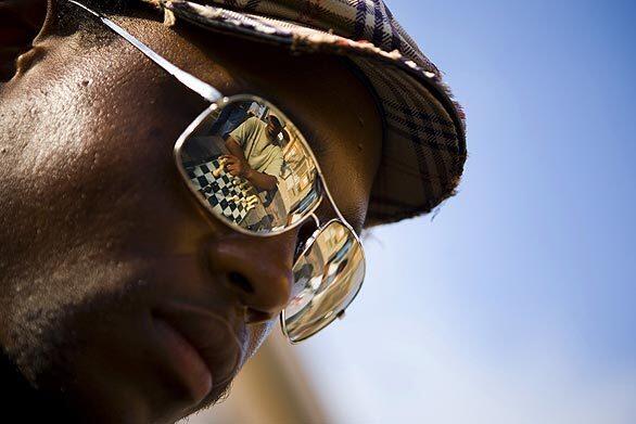Andrew Cromartie, 26, of Stamford, Conn., is reflected in the sunglasses of playing partner Charles Dungey, 41, at the chess park near the Santa Monica Pier. Cromartie, who has been playing for about five years, is in the area on a business trip and tries to get to the chess park a few times each week.