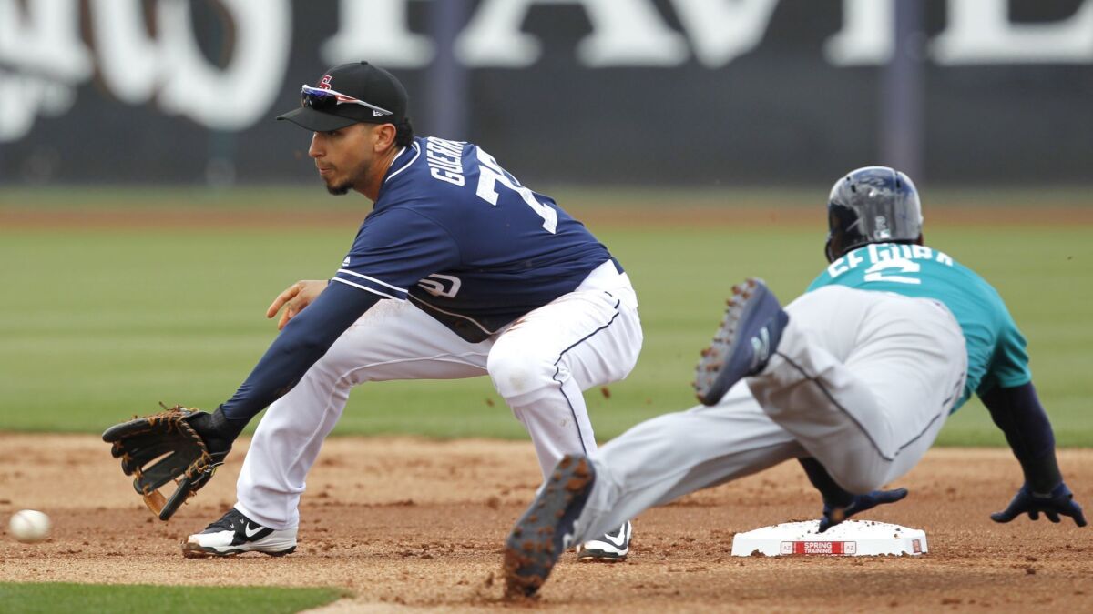 A ball gets by San Diego Padres Javy Guerra as Seattle Mariners Jean Seager steals second base during a spring training game in Peoria on Feb. 23, 2018.
