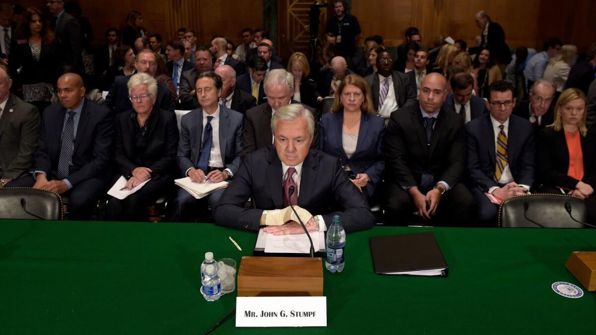 Former Wells Fargo CEO John Stumpf, shown preparing to testify in Washington last year, will have to give up another $28 million in back pay in the aftermath of an investigation into the bank's fake-account scandal.