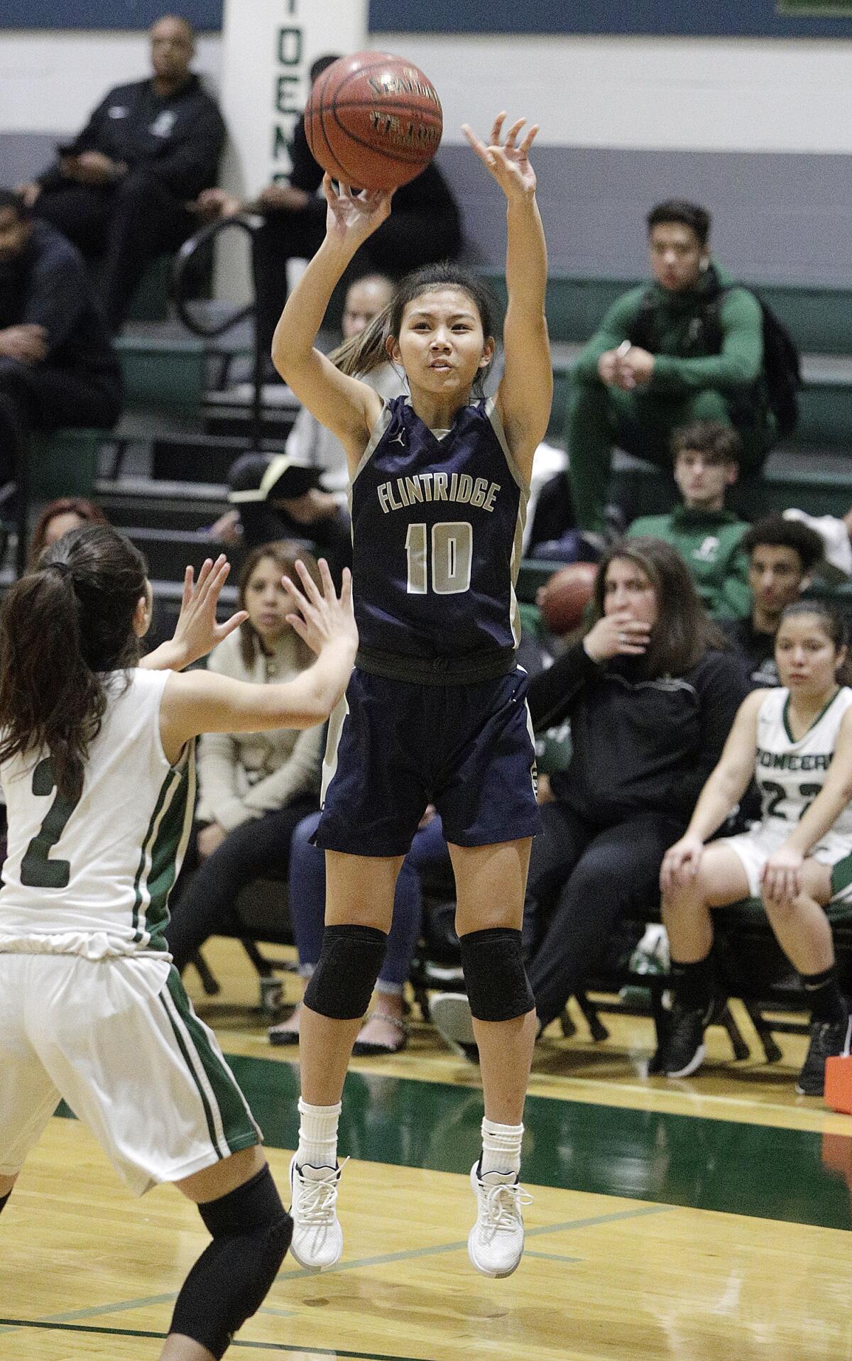 Flintridge Prep's Mikaylie Kiyomura posts up and shoots with Providence's Katelyn Alavarado defending in a Prep League girls' basketball game at Providence High School on Friday, January 10, 2020.