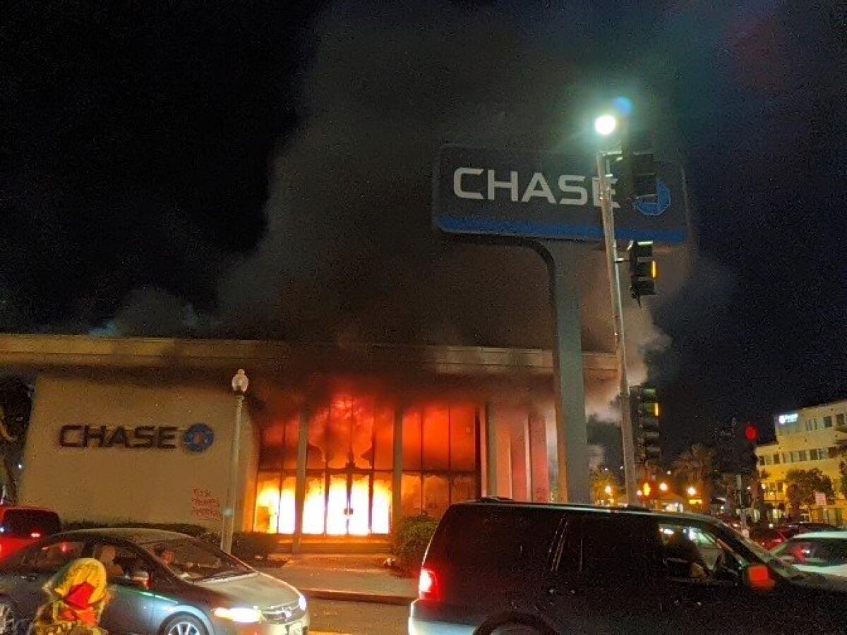 Chase bank in downtown La Mesa burns unchecked during Saturday's riot.