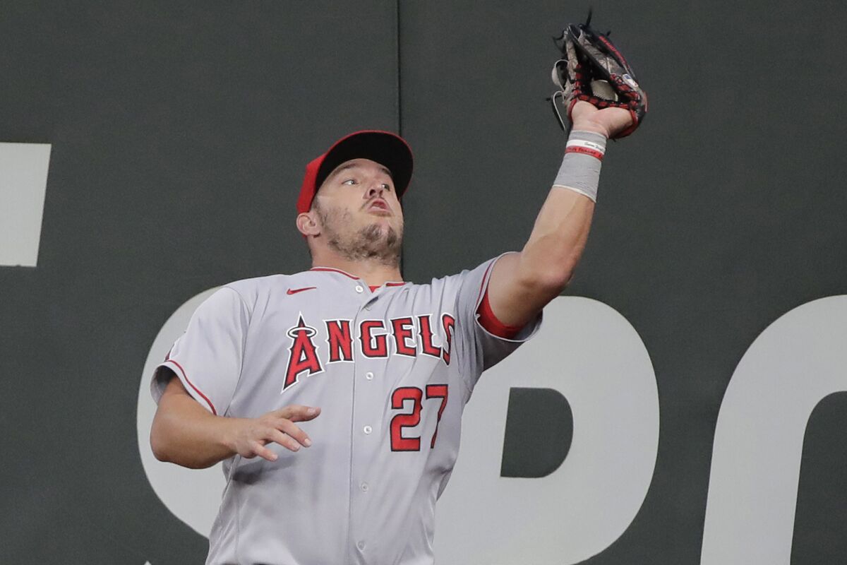 Los Angeles Angels center fielder Mike Trout catches a fly ball hit by Seattle Mariners' Dylan Moore at the wall during the fifth inning of a baseball game Tuesday, Aug. 4, 2020, in Seattle. (AP Photo/Ted S. Warren)