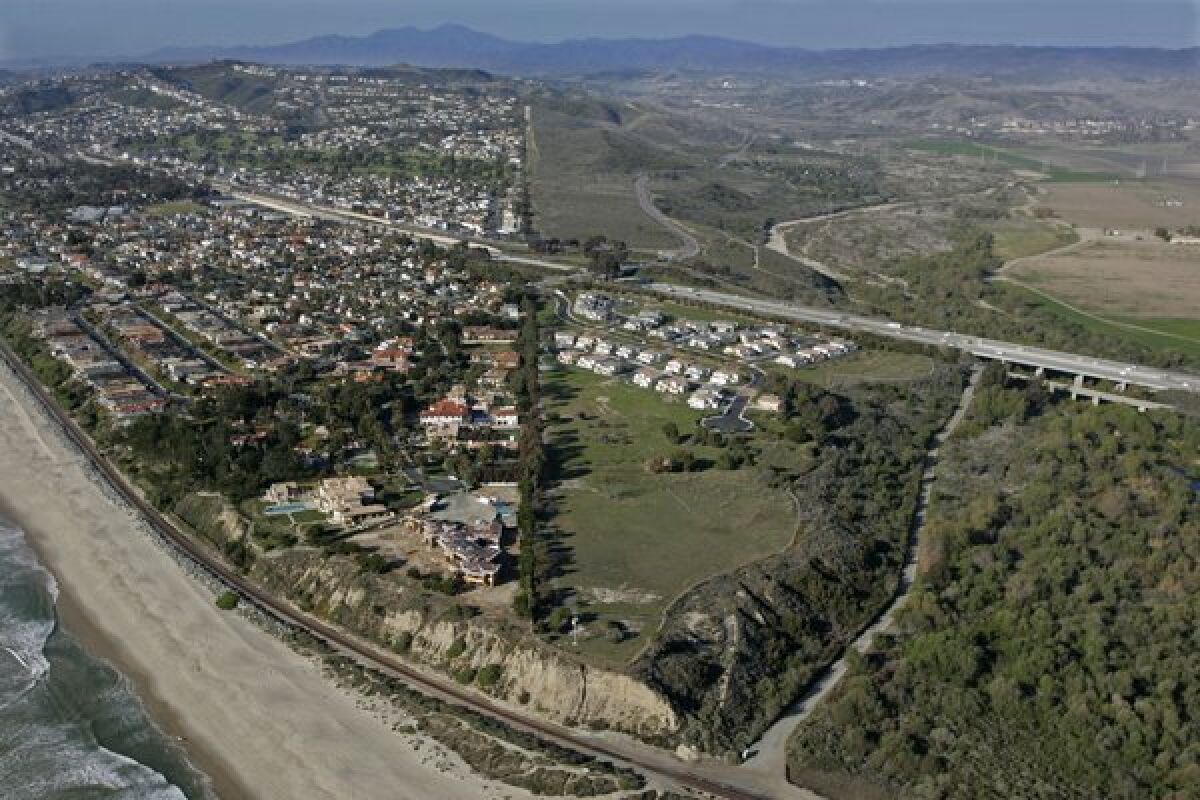 Camp Pendleton's borderline bisects this aerial view. Looking north, San Clemente at the left and San Onofre State Beach park to the right.
