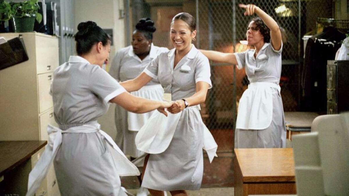 Jennifer Lopez portrays Marisa Ventura, center, a hotel maid in "Maid in Manhattan." (K.C. Bailey / Columbia Pictures)