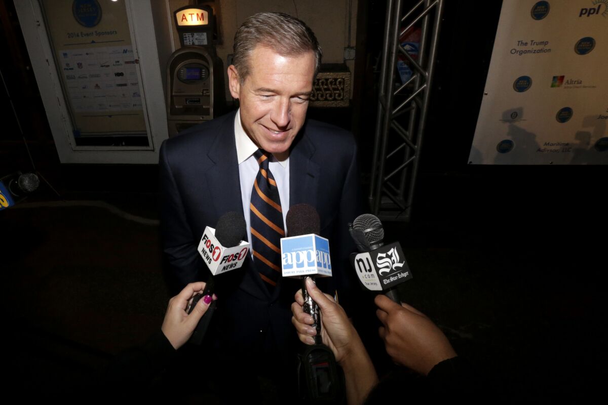 FILE - In this Thursday, Nov. 13, 2014, file photo, television journalist Brian Williams arrives at the Asbury Park Convention Hall during red carpet arrivals prior to the New Jersey Hall of Fame inductions, in Asbury Park, N.J. Williams says he's leaving NBC News when his contract ends in December 2021. (AP Photo/Julio Cortez, File)