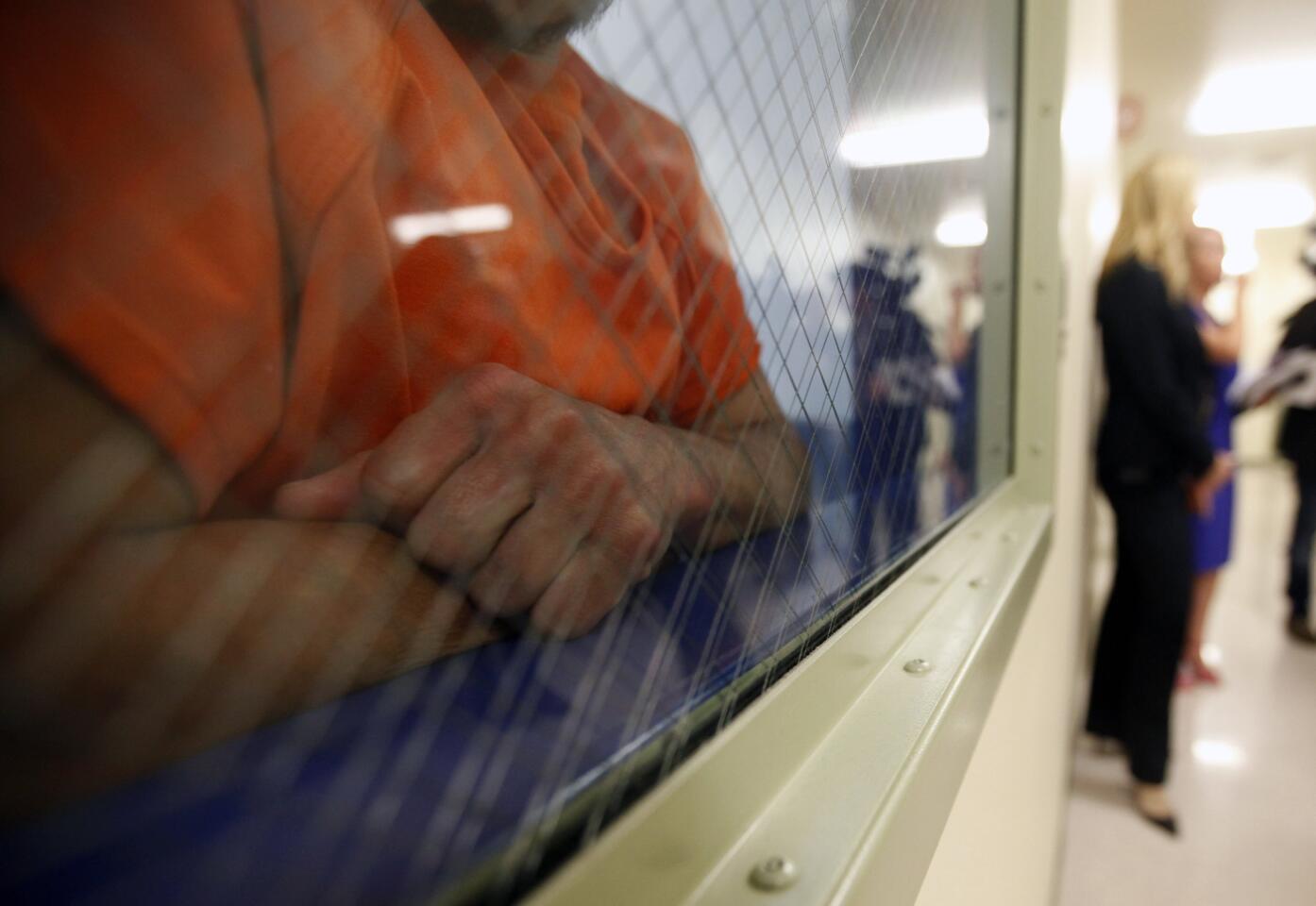 A detainee looks out from a holding area at the new immigrant detention center in Bakersfield.