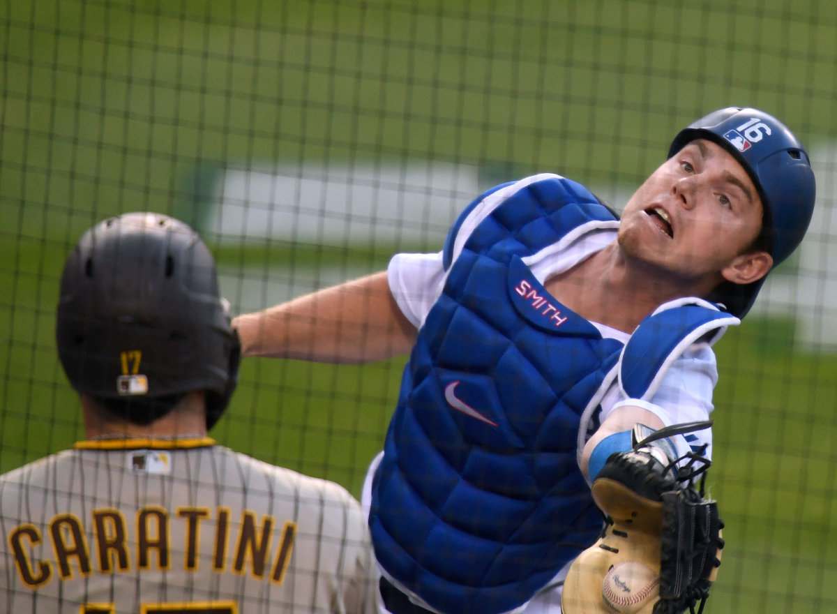 Dodgers catcher Will Smith drops a pop fly in foul territory in front of San Diego's Victor Caratini.