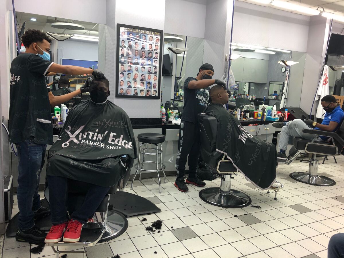 John James gets his hair cut at Kuttin’ Edge barber shop in Houston’s Galleria Mall.