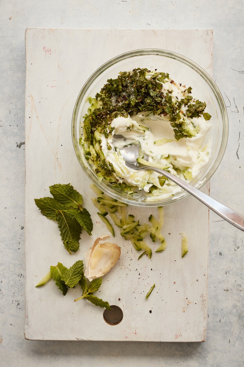 Strained yogurt is mixed with cucumber, garlic and salt and pepper, then chilled until ready to serve, with fresh mint.