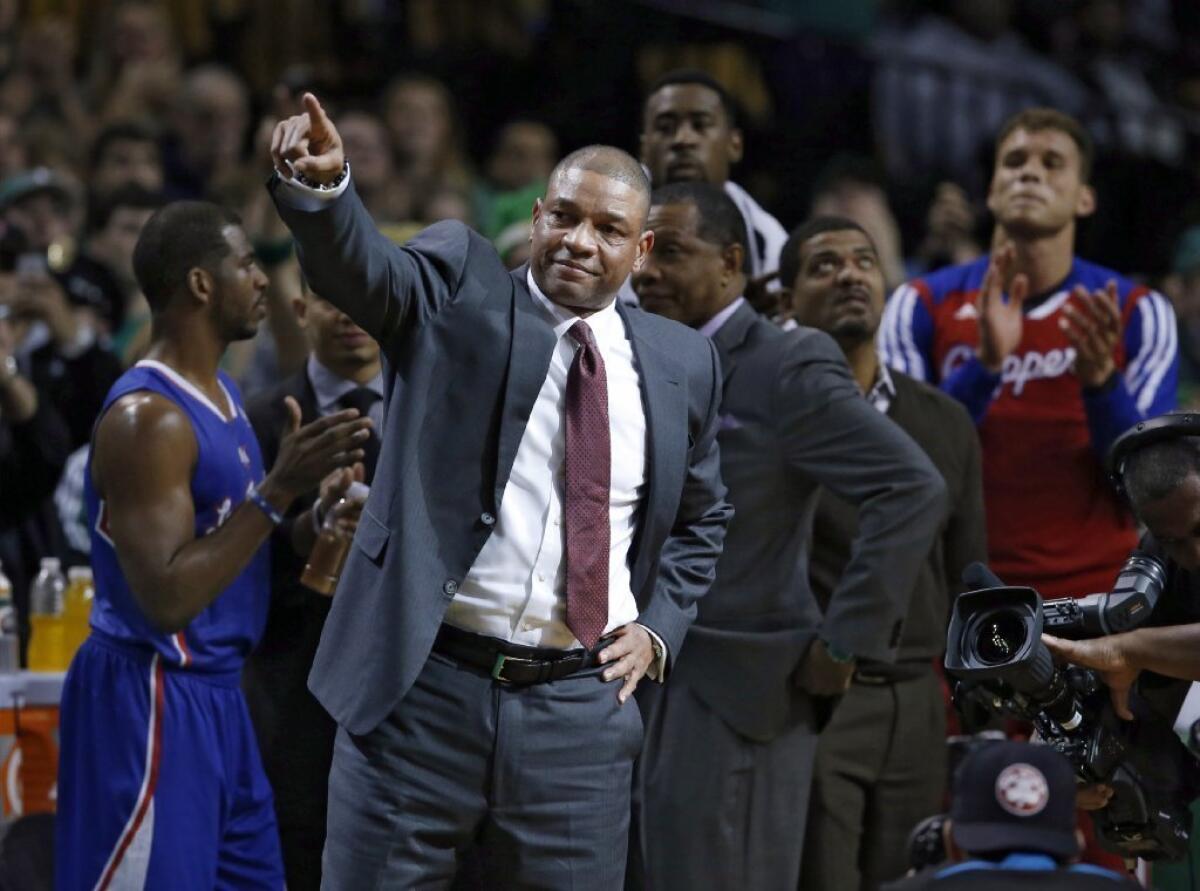 Clippers Coach Doc Rivers acknowledges fans during a video tribute to him in his first time back to the TD Garden in Boston on Wednesday.