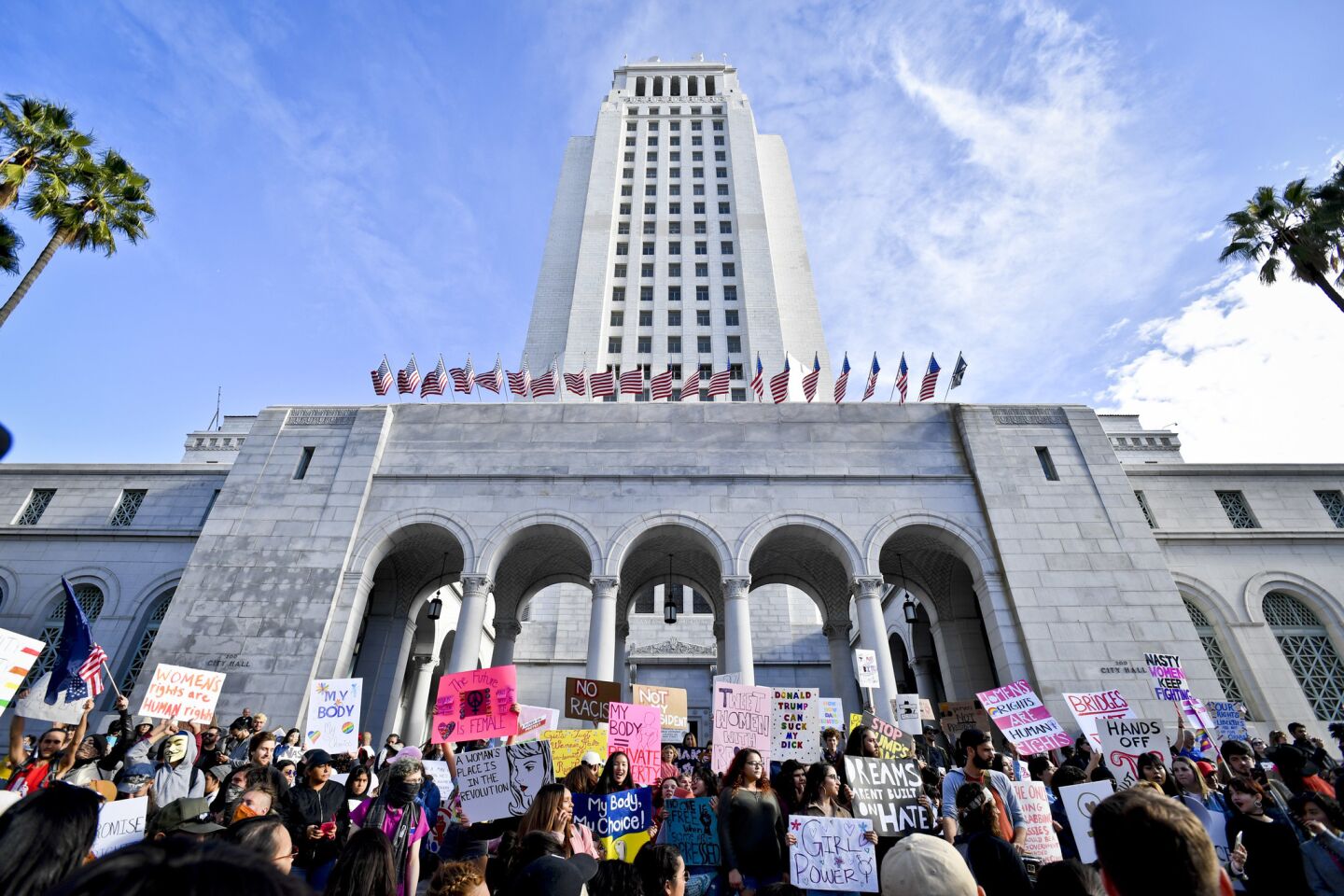 Demonstrators line the steps of City Hall while chanting slogans and dancing after the women's march in downtown Los Angeles.