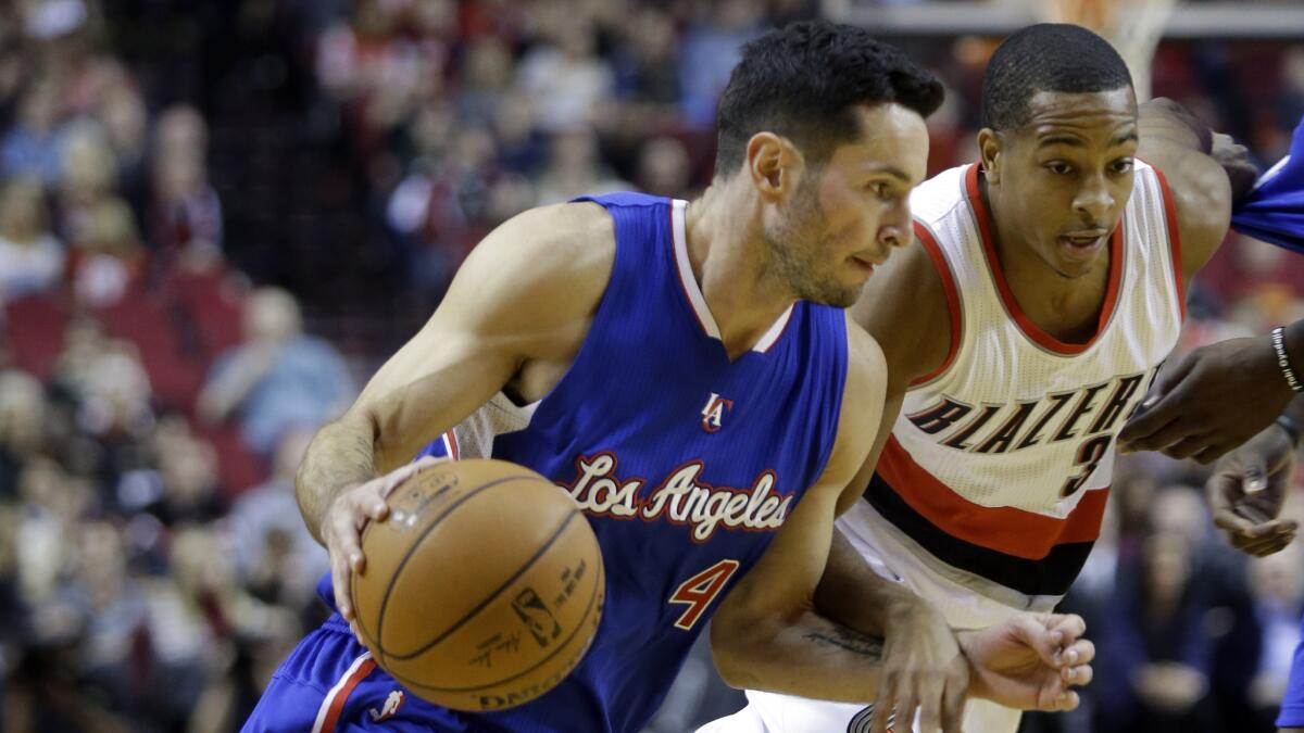 Clippers guard J.J. Redick, left, drives past Portland Trail Blazers guard CJ McCollum during the first half of a preseason game on Oct. 12.