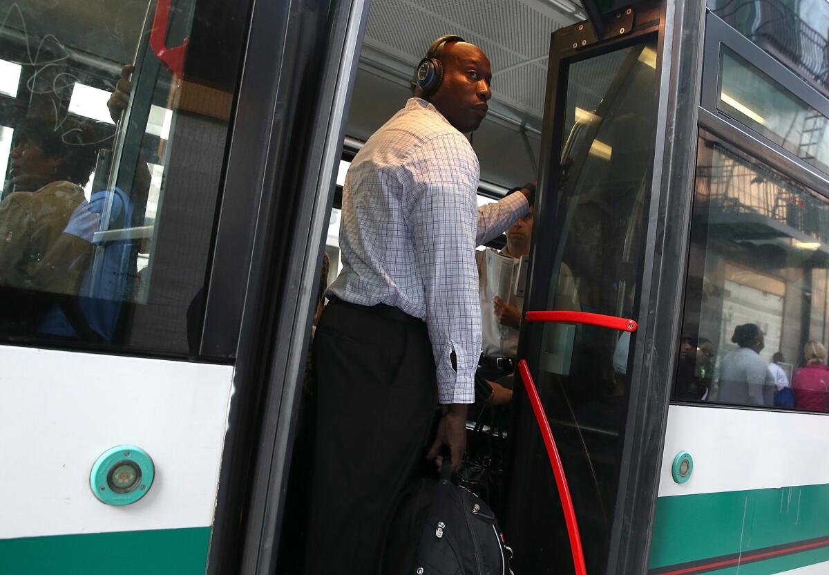 A commuter stands inside an Alameda-Contra Costa (AC) Transit bus in Oakland. Transit workers are threatening to strike starting at 12:01 a.m. Wednesday.
