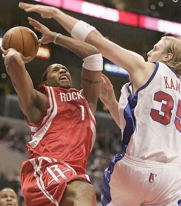 Houston's Tracey McGrady is fouled by Clipper Chris Kaman during first half action.