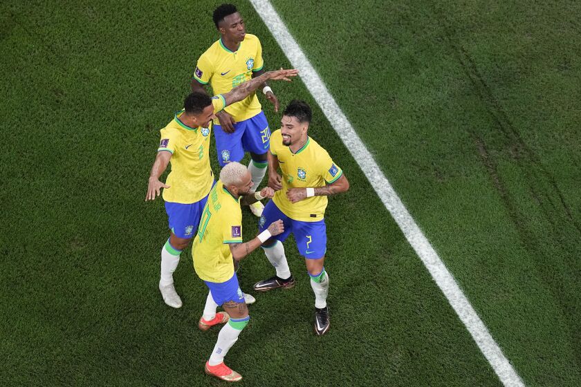 Brazil's Vinicius Junior, Danilo and Neymar dance with Lucas Paqueta, right, after he scored his side's fourth goal during the World Cup round of 16 soccer match between Brazil and South Korea, at the Stadium 974 in Al Rayyan, Qatar, Monday, Dec. 5, 2022. (AP Photo/Pavel Golovkin)
