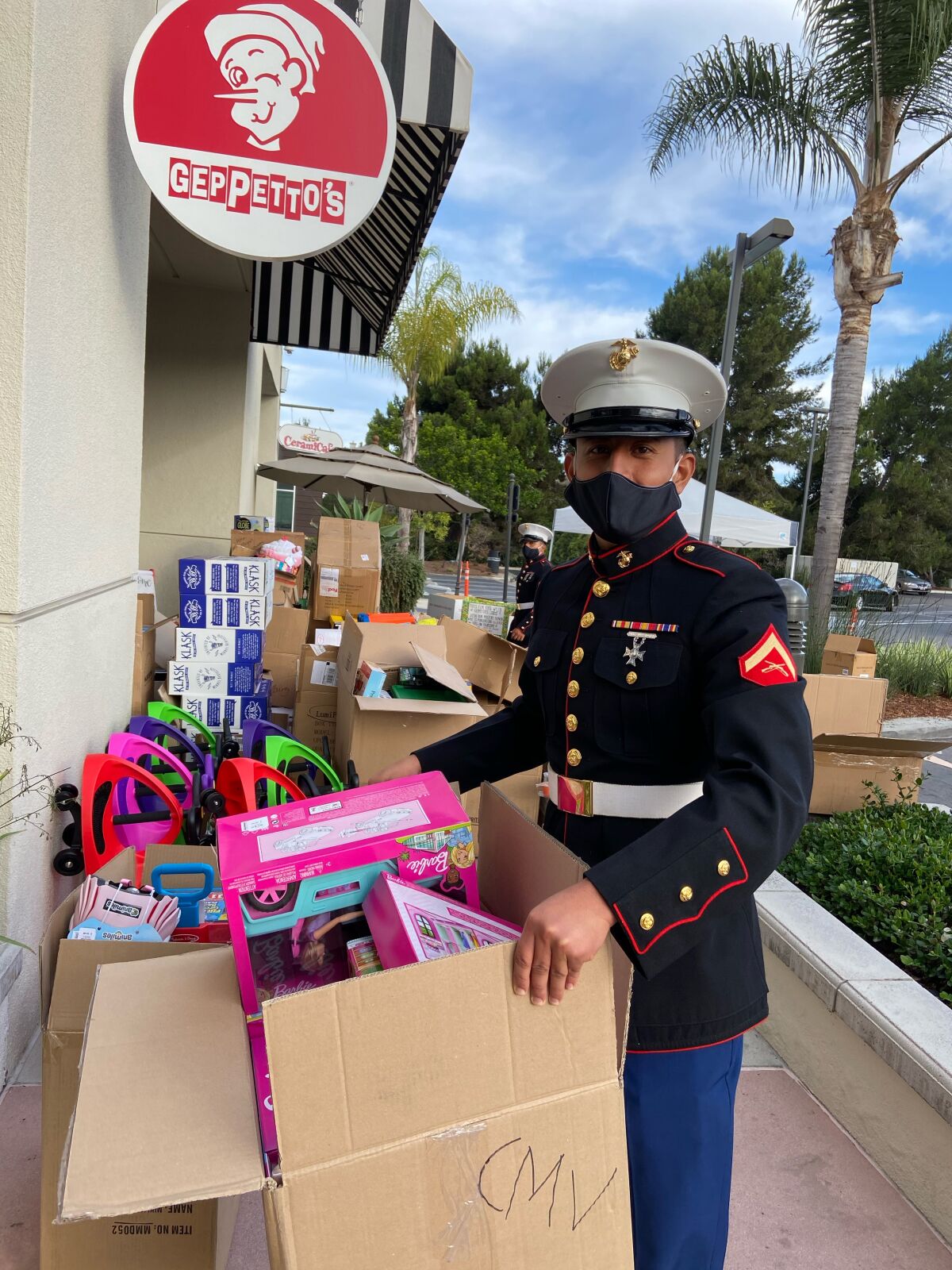 A Marine loads up Toys for Tots donations at Geppetto's in Del Mar Highlands Town Center.