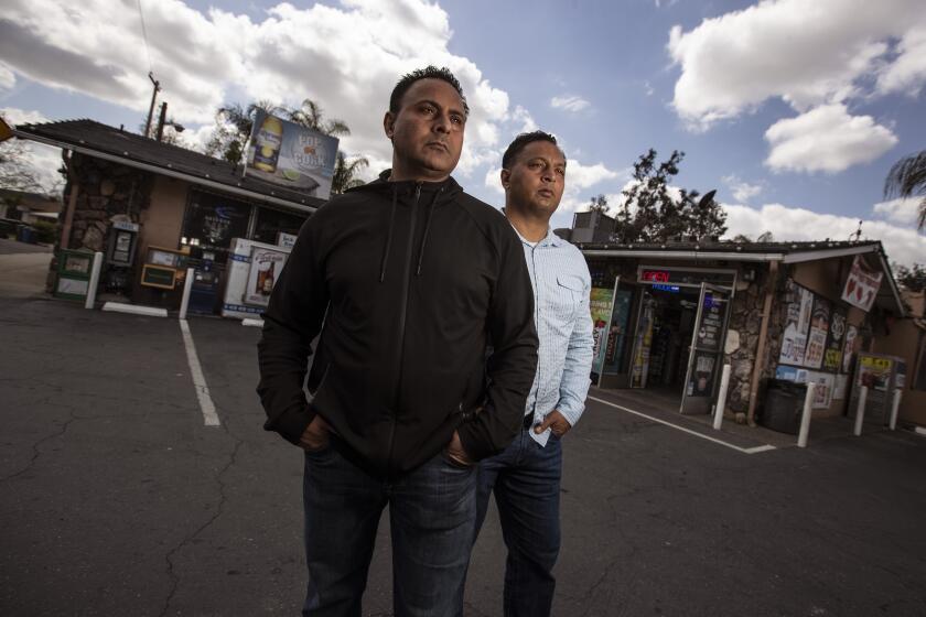 TURLOCK, CA - MARCH 25: Brothers Baljit "Bobby" Athwal, right, and Daljit "Dee" Atwal, left, stand for portraits at their Pop-N-Cork liquor store on Thursday, March 25, 2021 in Turlock, CA. (Brian van der Brug / Los Angeles Times) *IMAGES FOR CHRISTOPHER GOFFARD STORY
