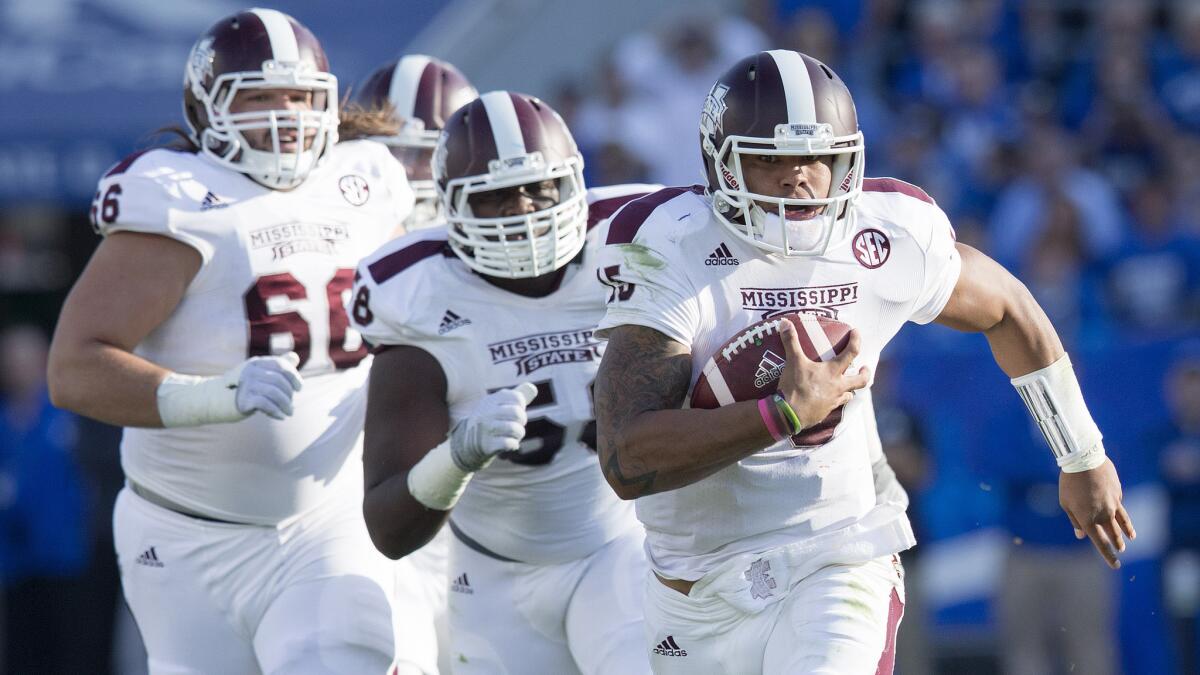 Mississippi State quarterback Dak Prescott runs for a first down in front of his teammates during Saturday's win over Kentucky.