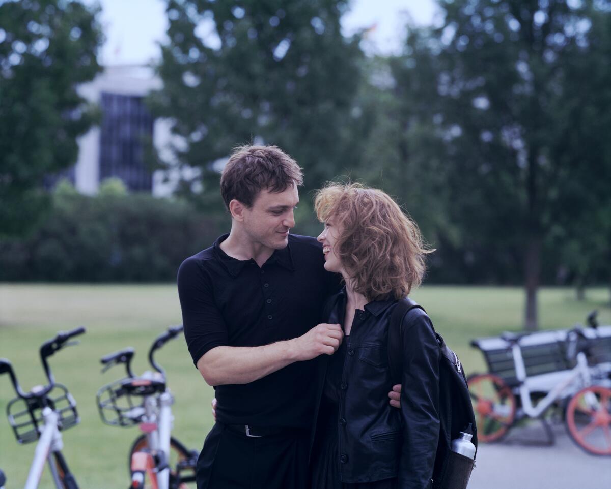 Franz Rogowski and Paula Beer walk around Berlin in the movie "Undine."