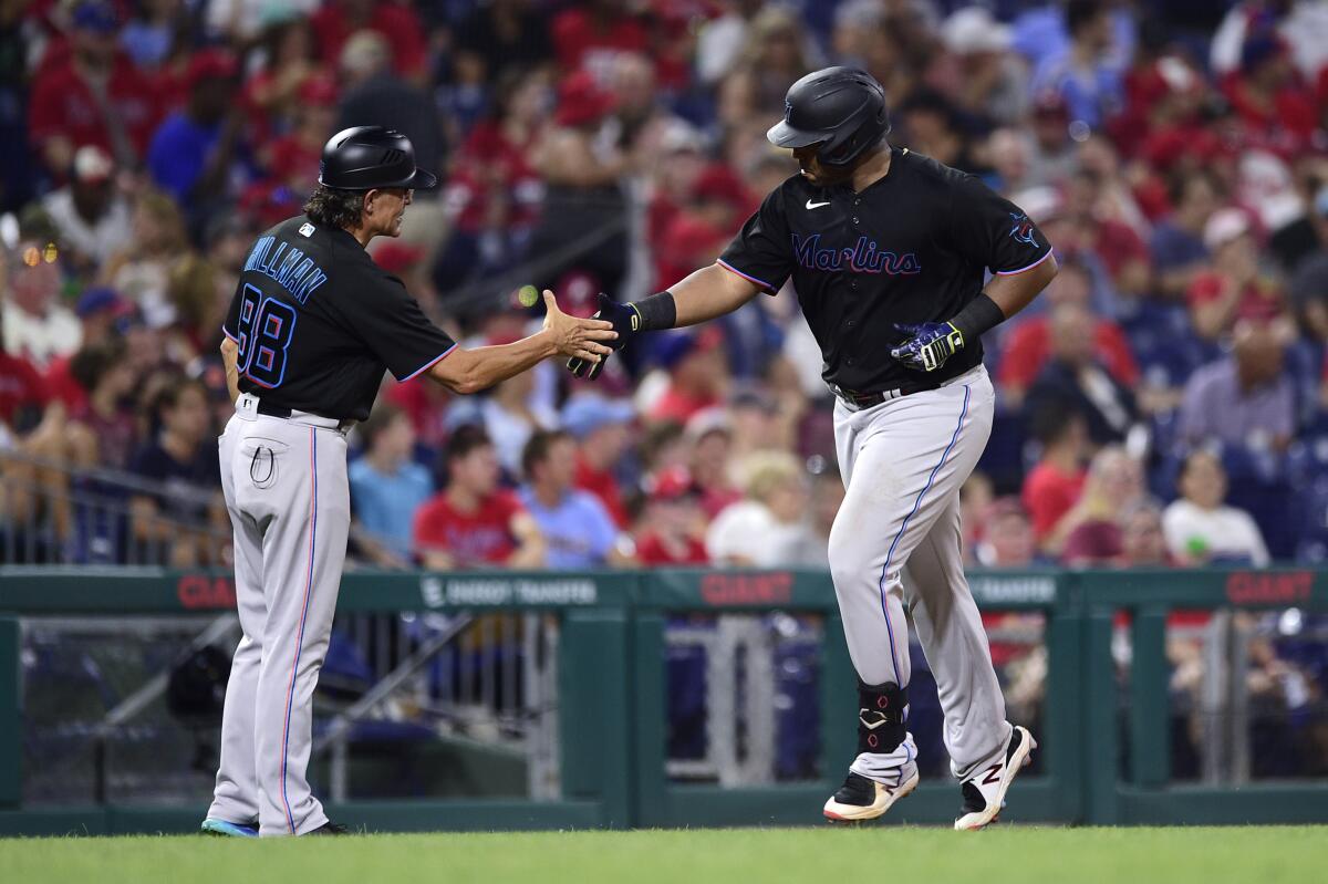 Miami Marlins' Jesus Sanchez, left, is congratulated by first base
