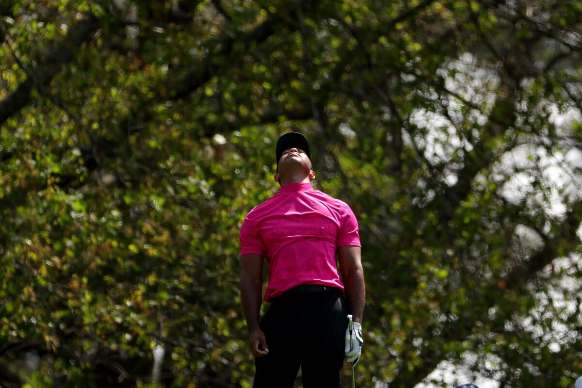 Tiger Woods reacts to his shot from the fourth tee.