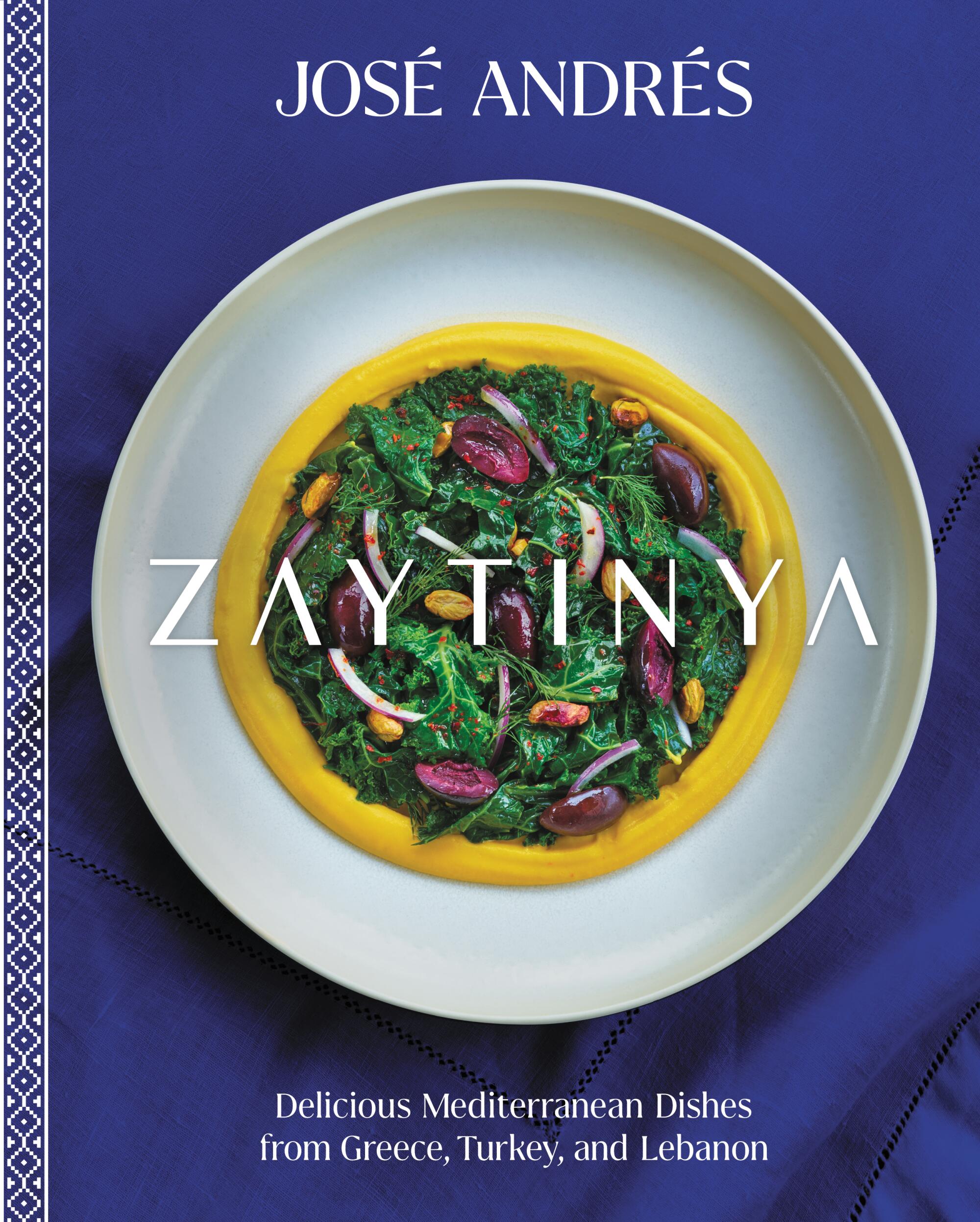 A photo of the cover of the Zaytinya cookbook: Dark blue with greens atop a yellow spread at the center of the book.