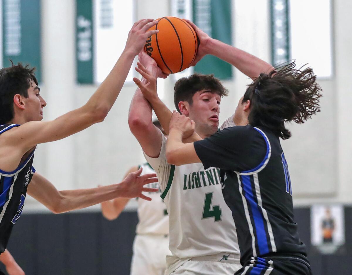Sage Hill's Johnny Mayhew (4) is swarmed by defenders Grayson Senik and Sebastian Esparza, from left, on Tuesday.