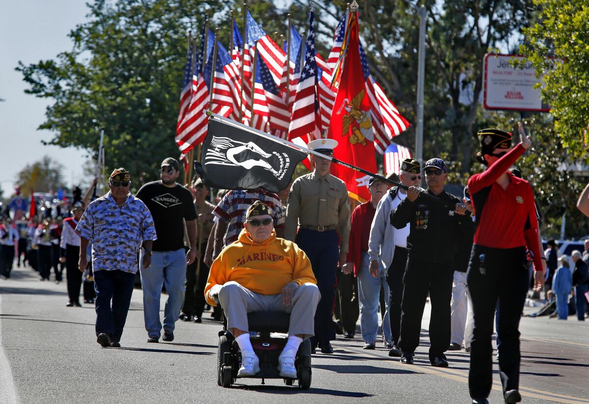 Former U.S. Marine Andrew Genninger, 87, leads the annual Veterans Day parade in Fallbrook. The veteran of World War II, Korea and Vietnam received a second lieutenant field commission during the Korean War.