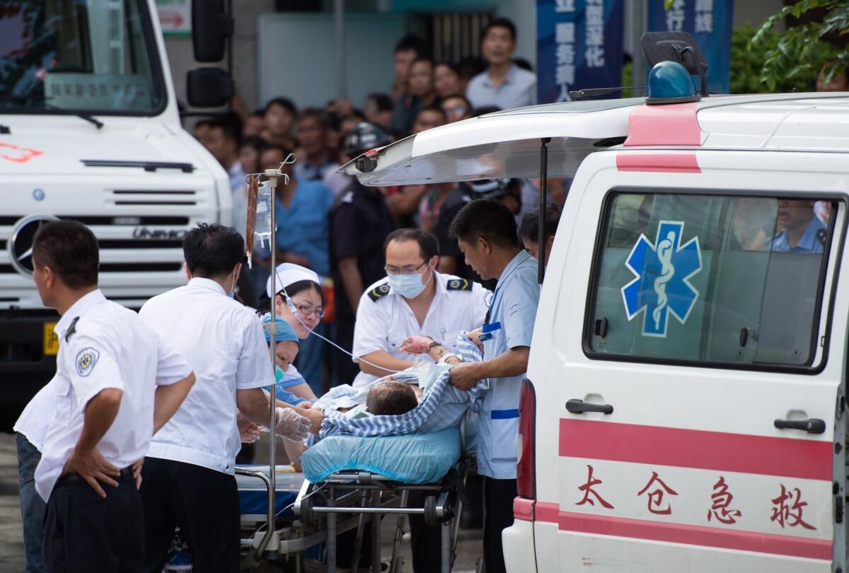 A victim of a factory explosion is wheeled into a hospital in Kunshan, China, on Saturday.