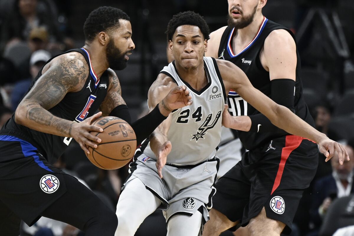 Clippers forward Marcus Morris, Sr. controls the ball in front of San Antonio Spurs guard Devin Vassell.
