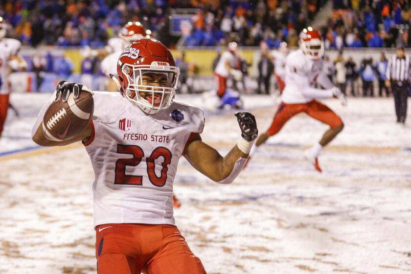Fresno State running back Ronnie Rivers (20) celebrates the game winning touchdown against Boise State in overtime against in an NCAA college football game for the Mountain West championship, Saturday, Dec. 1, 2018, in Boise, Idaho. Fresno State won 19-16. (AP Photo/Steve Conner)
