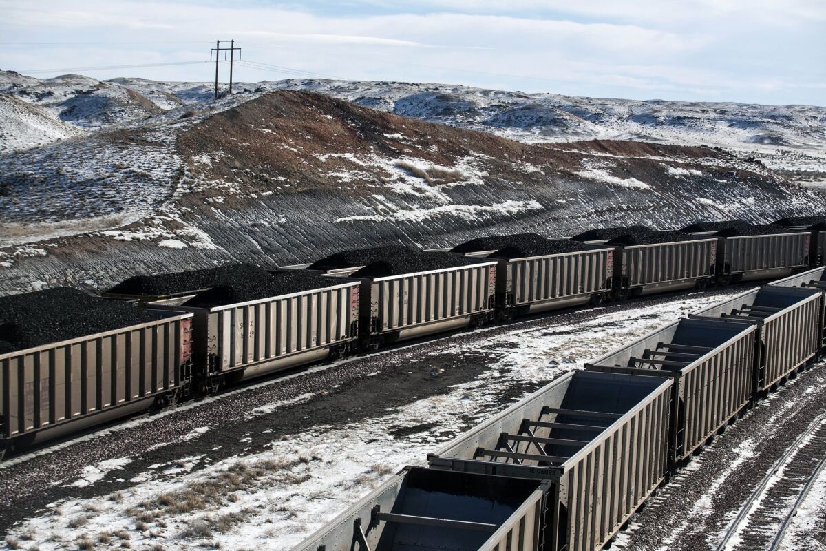 Rail cars are filled with coal and sprayed with a topper agent to suppress dust at Cloud Peak Energy's Antelope Mine north of Douglas, Wyo.