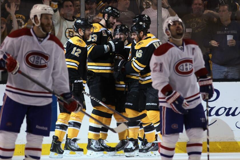 Members of the Boston Bruins celebrate a power-play goal by Jarome Iginla early in the second period against the Montreal Canadiens on Saturday night.