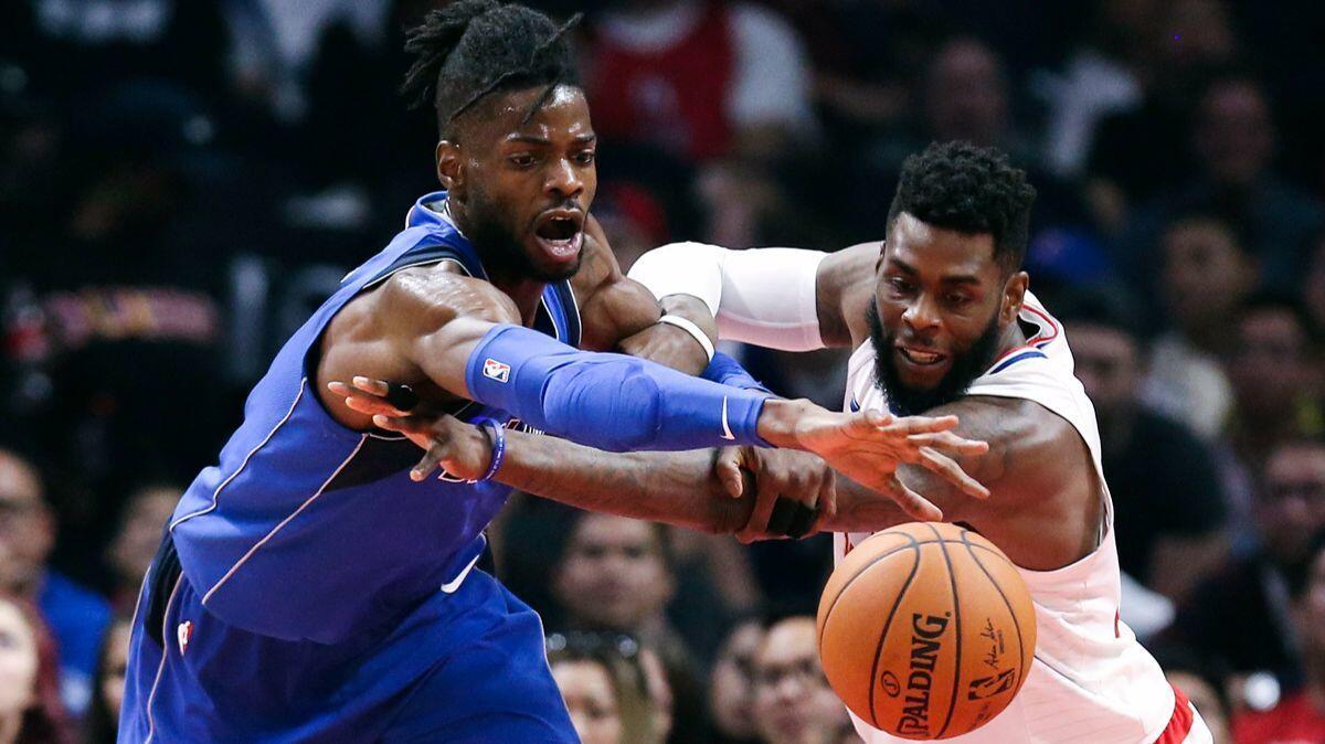 Dallas Mavericks center Nerlens Noel, left, and Clippers forward Willie Reed fight for a ball during the first half on Wednesday.