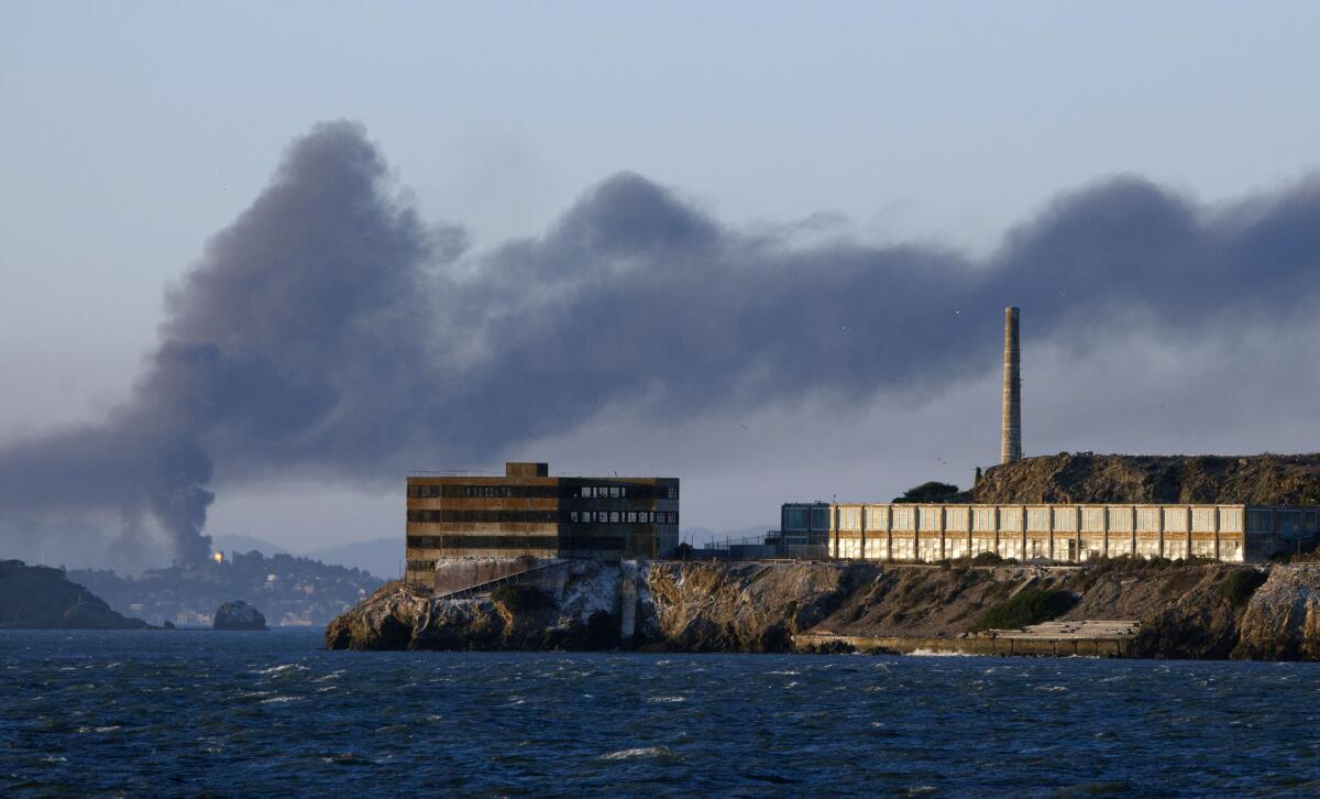 Smoke from a fire at the Chevron Richmond Refinery drifts over San Francisco Bay in august 2012. In the foreground, Alcatraz.