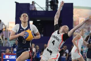 The United States' Dearica Hamby drives to the basket as Canada's Kacie Bosch guards her during women's 3x3 basketball 