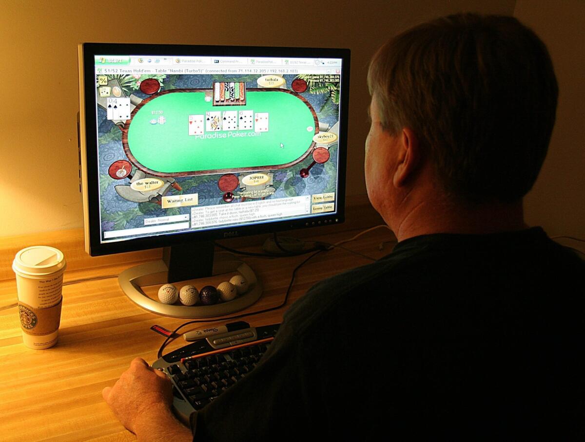 A Manassas, Va., man plays poker on his computer connected to an Internet gaming site.