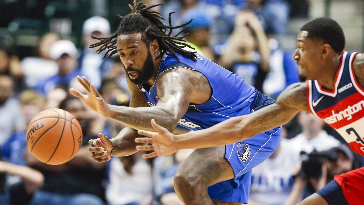 Dallas center DeAndre Jordan and Washington guard Bradley Beal track down a loose ball during a game earlier this season.